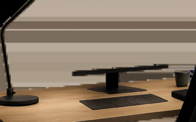 Un bureau moderne équipé d’une lampe orientable qui éclaire précisément la zone de travail. L’image met en avant un espace sobre, fonctionnel et adapté au travail sur écran.